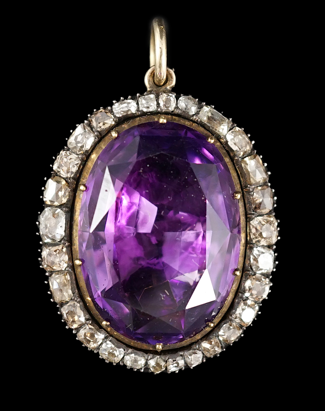 An early 19th century, gold and oval cut foil backed amethyst set pendant, with old cut diamond set border and closed back setting